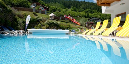Familienhotel - Hallenbad - Tiroler Oberland - Sicht vom Außenpool auf den großen Ritterspielplatz - Kinderhotel Laderhof