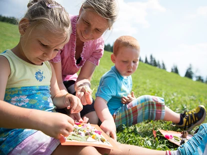 Familienhotel - Kinderbetreuung in Altersgruppen - Oberbozen - Ritten - Kinder auf der Wiese - Taser Alm