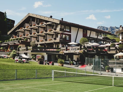 Familienhotel - Spielplatz - Hauseigener Tennisplatz direkt vor dem Burg Hotel  - Burg Hotel Oberlech