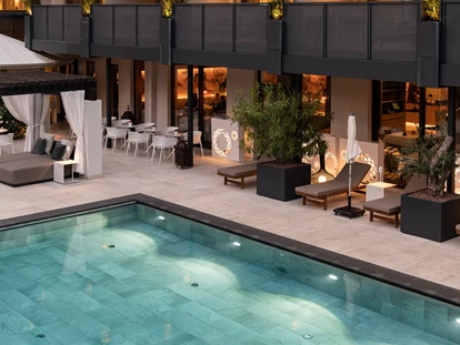 Familienhotel - Pools: Außenpool beheizt - Dimaro - Outdoorpool bei Nacht - Hotel das Paradies